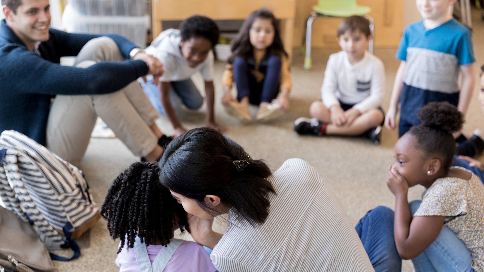 Students play a game of telephone.
